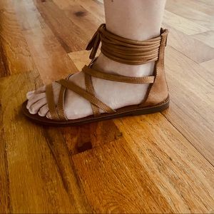 Natural brown leather sandals ankle tassel accents